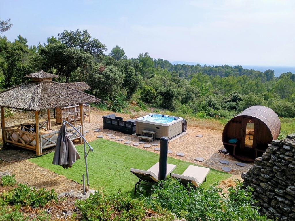 a backyard with a hot tub and a gazebo at Gîte Le Provence Spacieux 100m2 in Saumane-de-Vaucluse