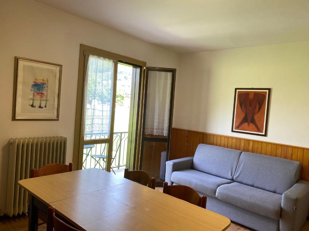 a living room with a table and a couch at Casa Silvia in Ledro