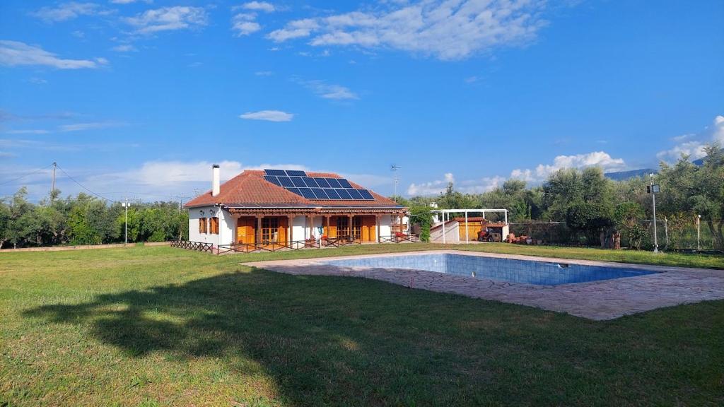 a house with a roof with a pool in the yard at Johnny Jo Villa in Aígio