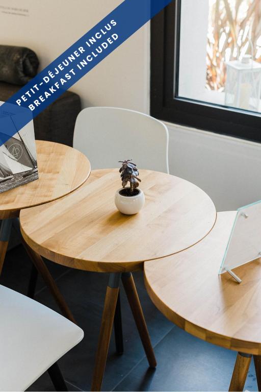 two wooden tables with a toy on top of it at Hôtel Les Voiles in Toulon