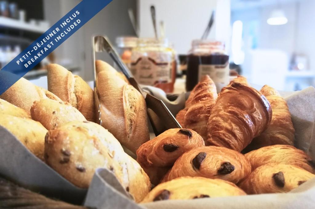 a bunch of different types of pastries in a basket at Hôtel Les Voiles in Toulon