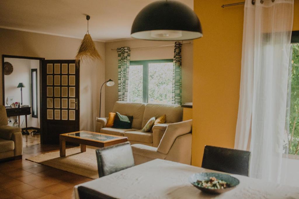 a living room with a couch and a table at Villa Clementina in Barcelos