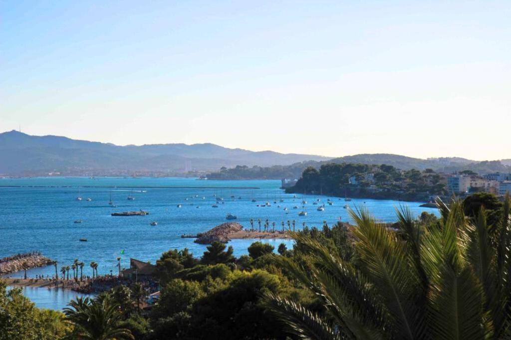 a beach with a bunch of boats in the water at Hôtel Les Voiles in Toulon