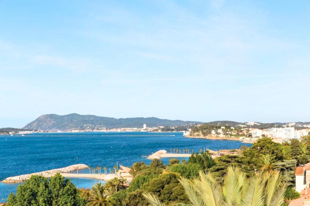 a view of a body of water with trees at Hôtel Les Voiles in Toulon