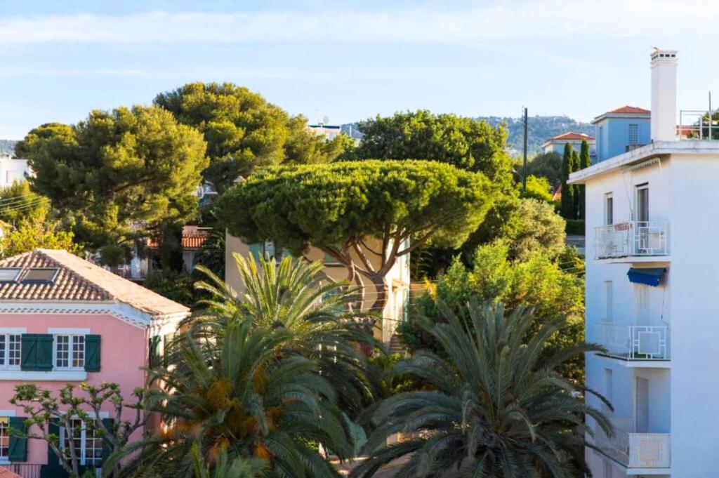 a view of a city with trees and buildings at Hôtel Les Voiles in Toulon