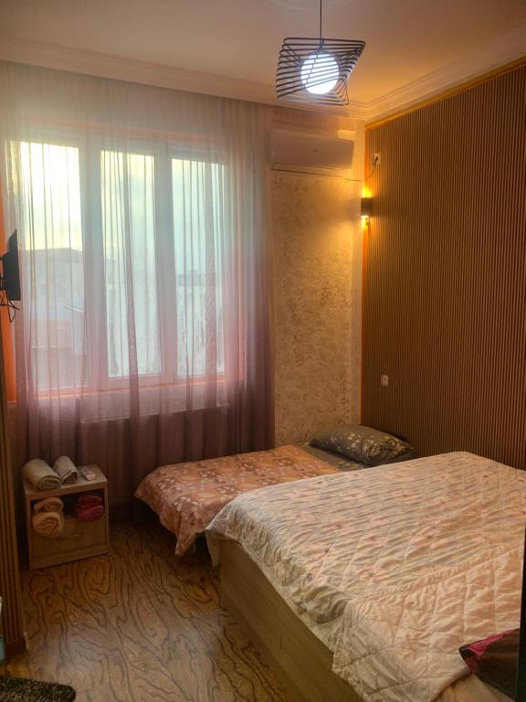 Postel nebo postele na pokoji v ubytování Guest House Kakha