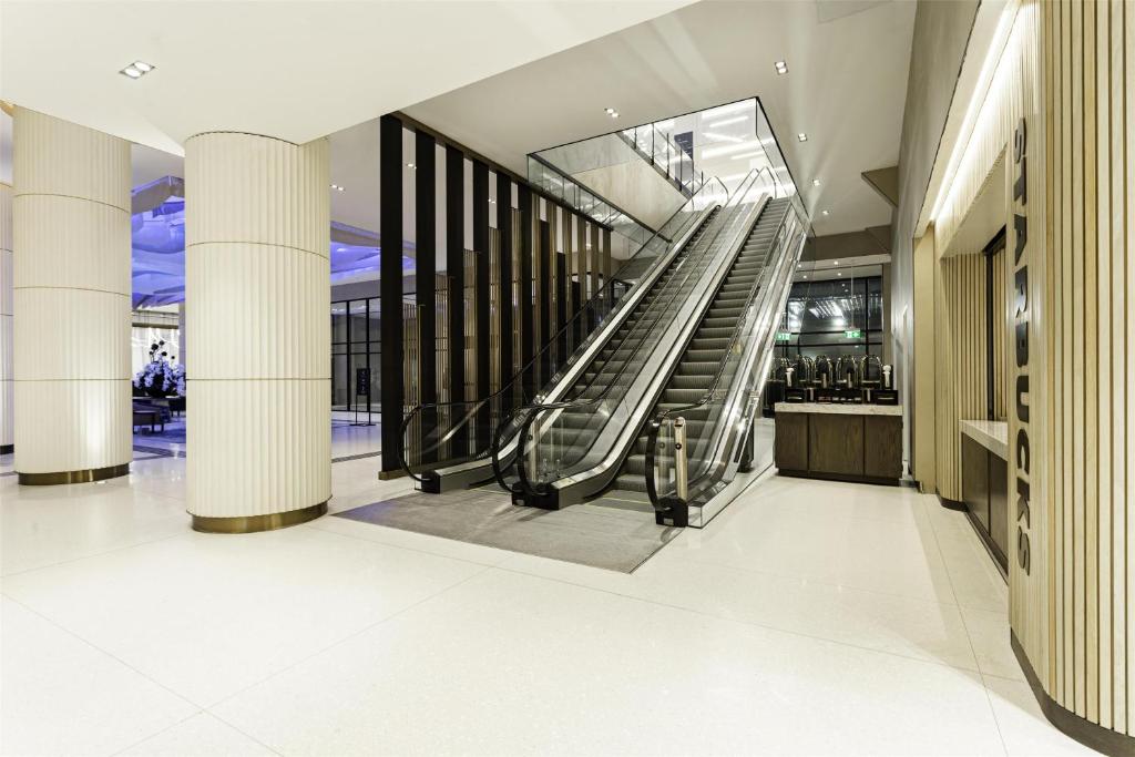 a lobby with an escalator in a building at Hilton Niagara Falls/ Fallsview Hotel and Suites in Niagara Falls