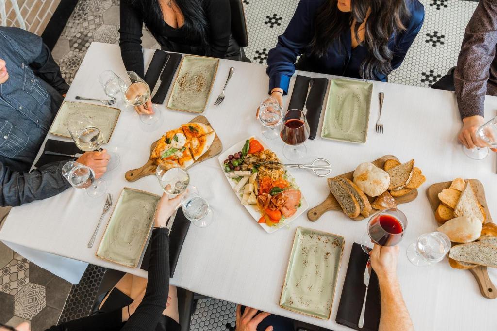 a group of people sitting around a table eating food at Hilton Niagara Falls/ Fallsview Hotel and Suites in Niagara Falls