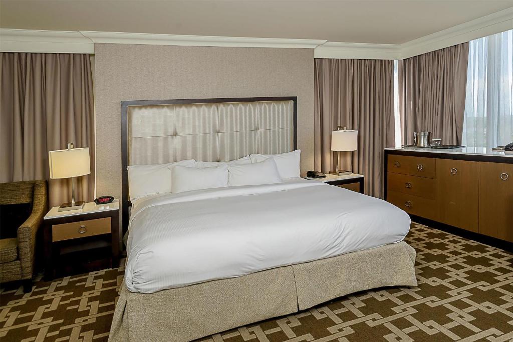 a large bed in a hotel room with two lamps at Hilton Niagara Falls/ Fallsview Hotel and Suites in Niagara Falls