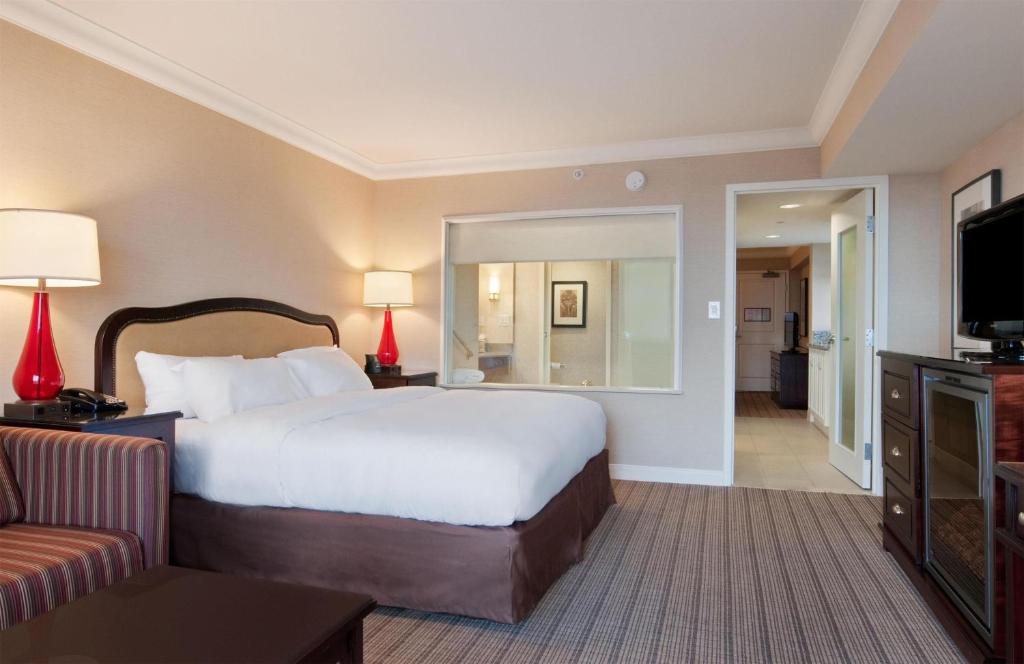 a hotel room with a large bed and a couch at Hilton Niagara Falls/ Fallsview Hotel and Suites in Niagara Falls