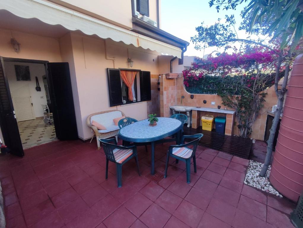 a patio with a blue table and chairs on a patio at Casa Rosanna in Porto Ottiolu
