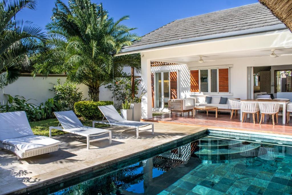 a villa with a swimming pool and a house at Comfortable villa with private pool in Grand-Baie