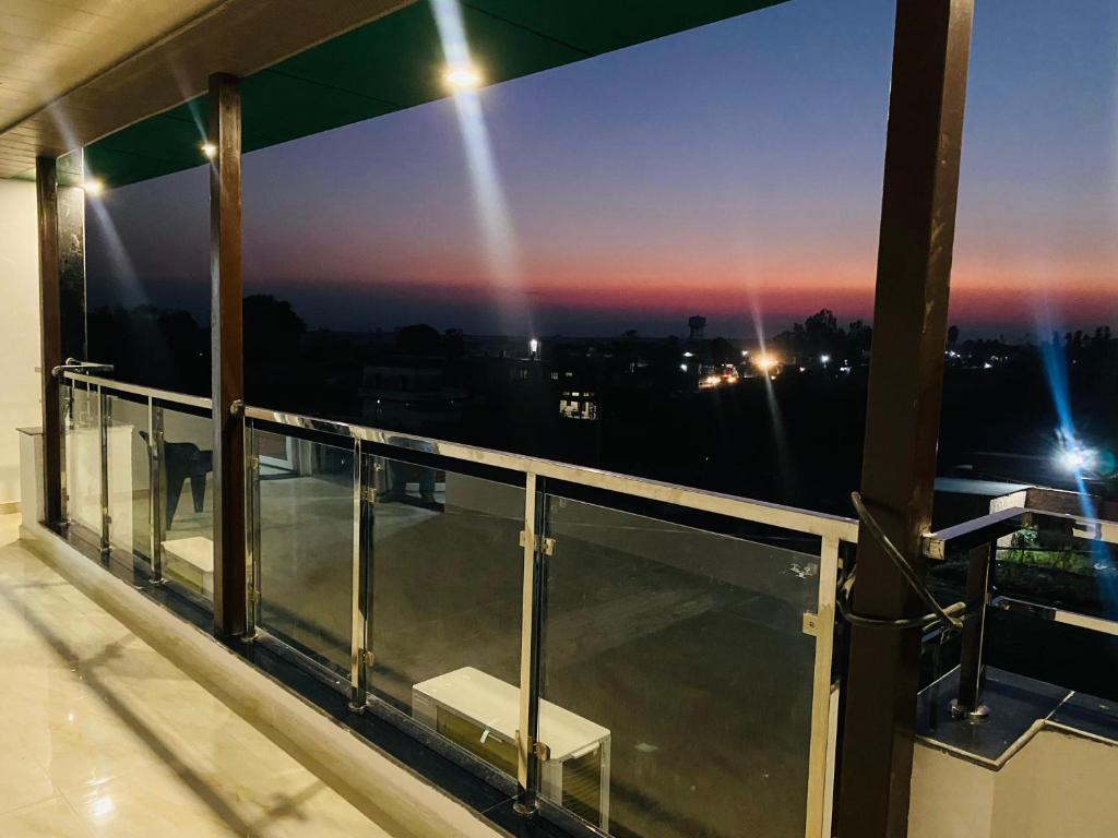 a balcony with a view of the city at night at DE AERO SUITES Near Dehradun Airport in Rāni Pokhri
