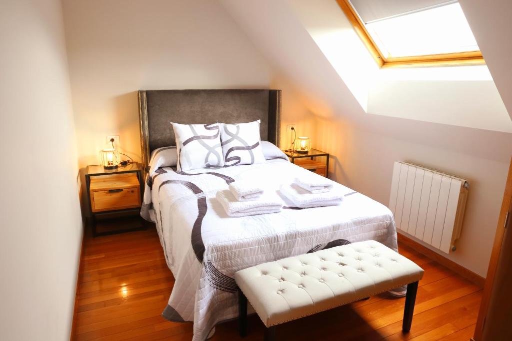 a bedroom with a bed and a skylight at Arel Dúplex in Lugo