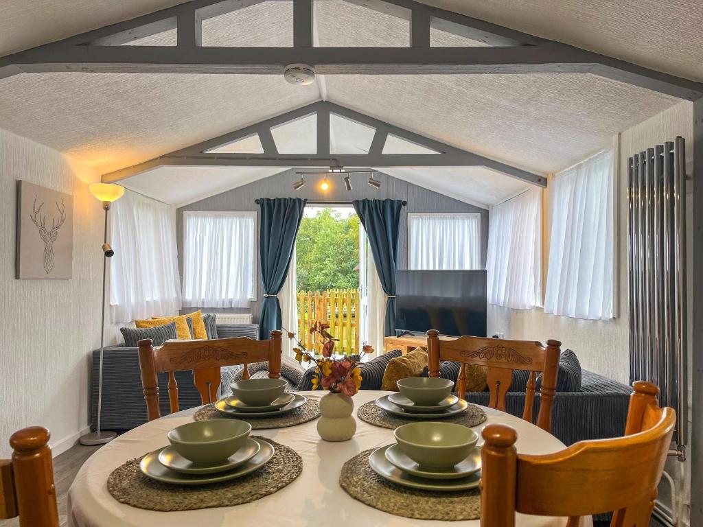 a dining room with a table and chairs at Lake View Cottage in Belper