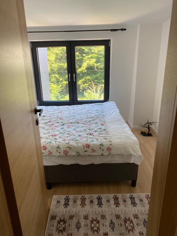 a small bedroom with a bed with a window at Mountain Dream in Bjelašnica
