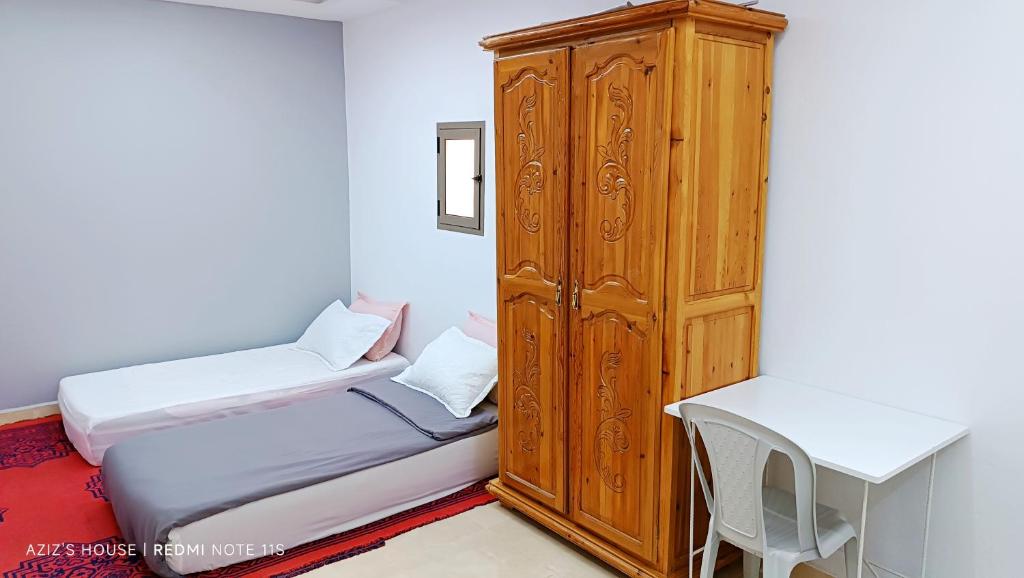 Una cama o camas en una habitación de Aziz House 1