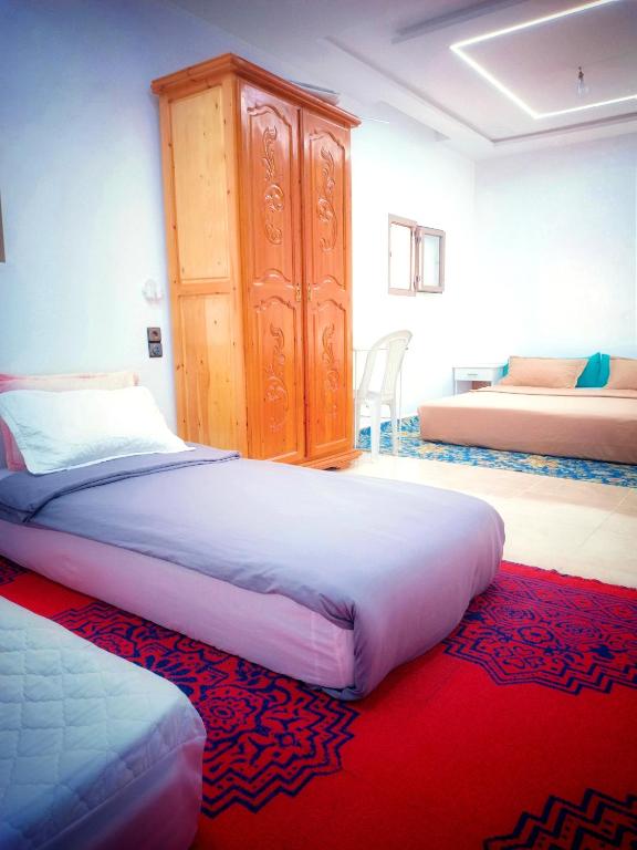 Una cama o camas en una habitación de Aziz House 1