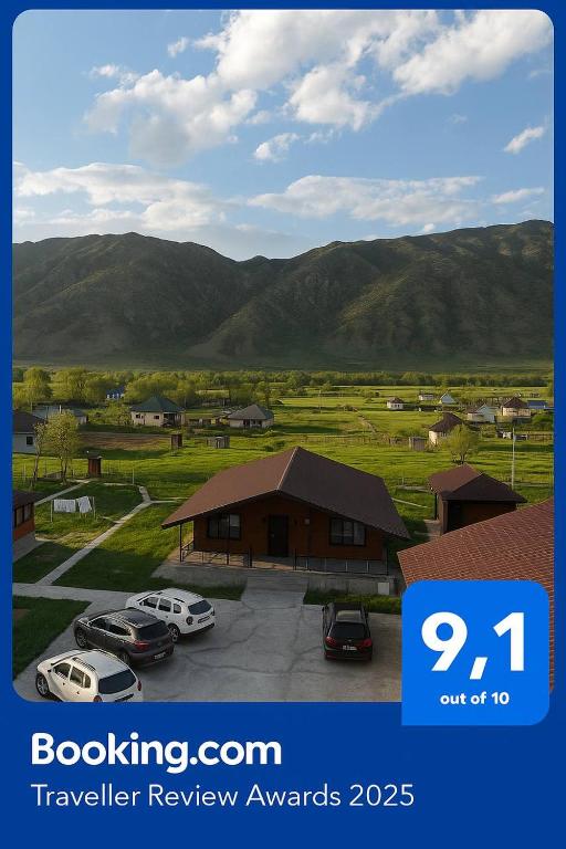 a picture of a car parking lot with mountains in the background at Kolsay Eco House in Saty
