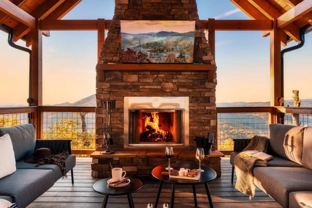 a living room with a fireplace with a view at 5 Suites - 180 View - Pool-Spa-Theater - Fireplace in Sevierville