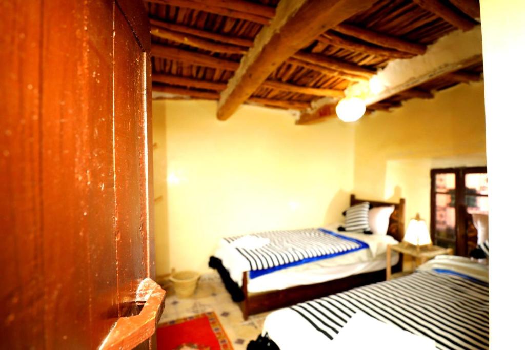 Postel nebo postele na pokoji v ubytování Atlas Kasbah Lodge