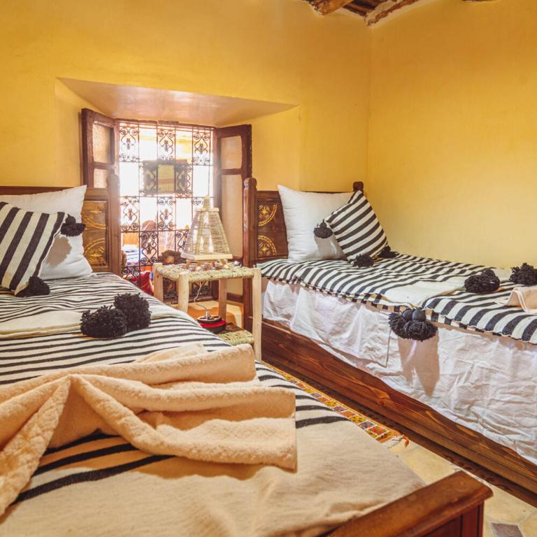 Postel nebo postele na pokoji v ubytování Atlas Kasbah Lodge