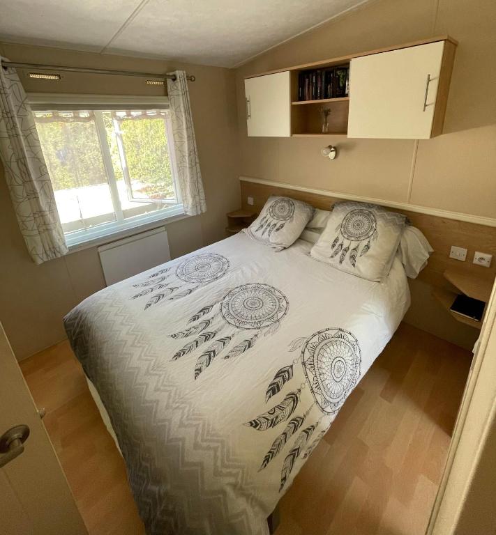 a bedroom with a large bed in a small room at Le grand air, mobil-home XXL in Lattes