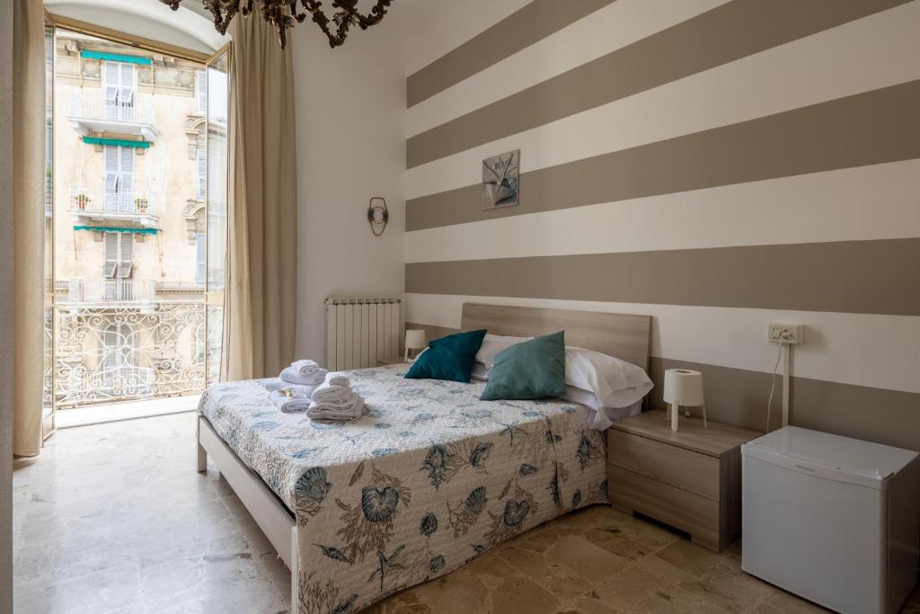 a bedroom with a bed and a striped wall at blu sea in La Spezia