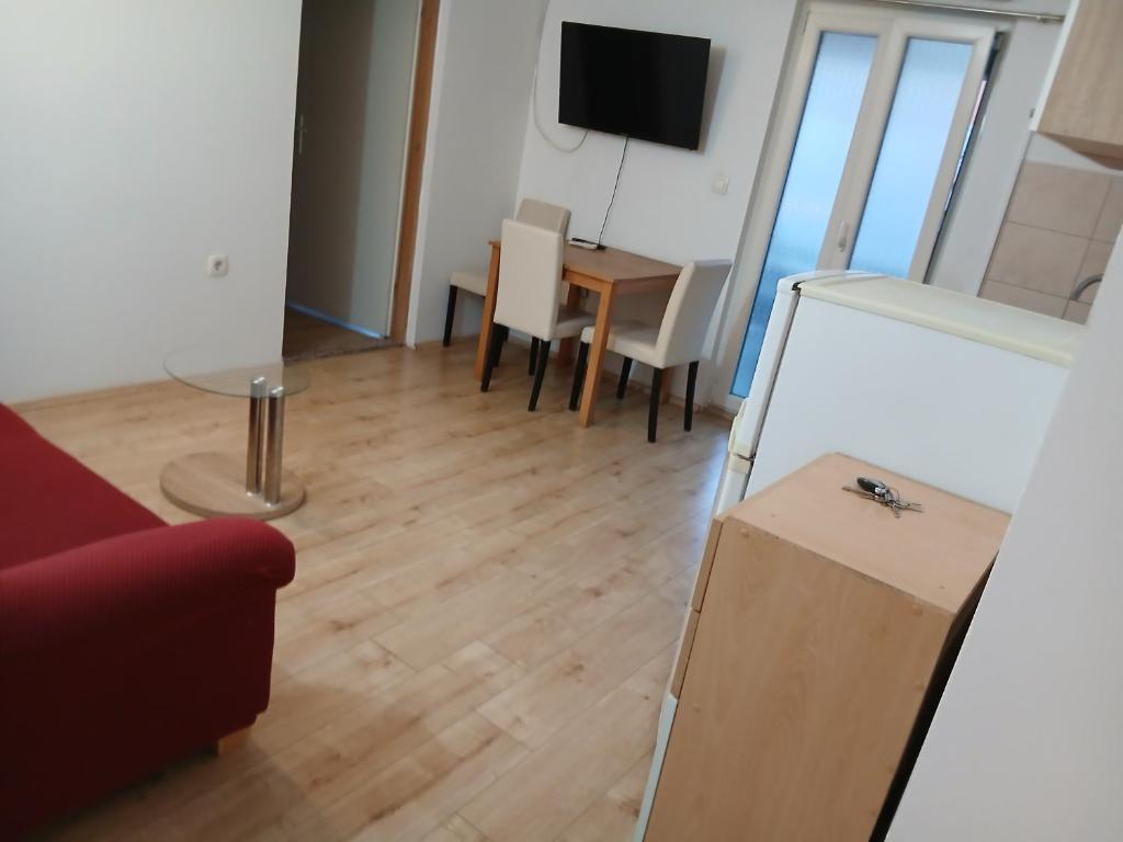 a living room with a couch and a table at Željko apartmani in Zadar