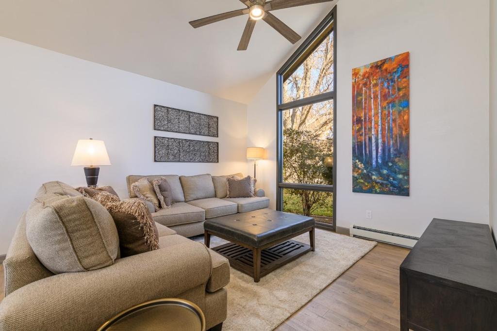 a living room with a couch and a table at Large 4 Bedroom Home with Hot Tub and Fenced Yard - NO XTRA FEES! in Grand Junction