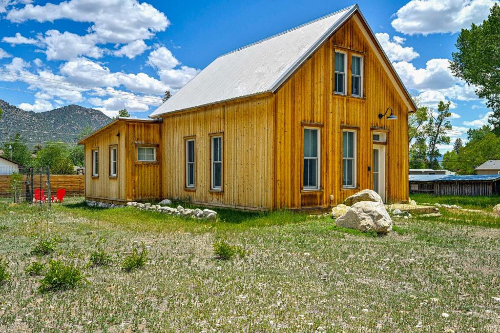 a wooden house in a field with a yard at Historic Home Near Main Street Buena Vista! in Buena Vista