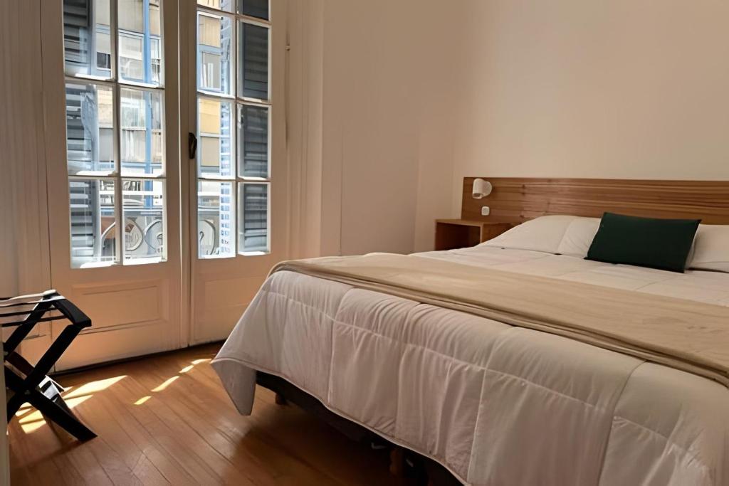 a bedroom with a large bed and a window at A metros de todo - Moderno. Hasta 7 pax. #26 in Buenos Aires