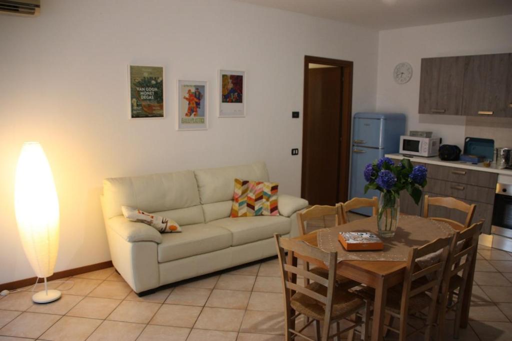 a living room with a couch and a table at Sotto la Rocca in Angera