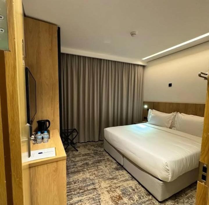 a hotel room with a bed and a television at Comfort sky Hotel11 in Cairo