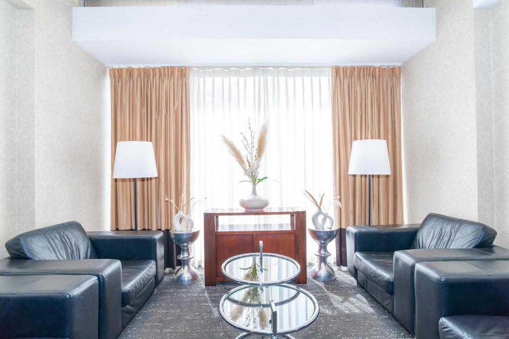 a living room with couches and a coffee table at Sandman Signature Vancouver Airport Hotel & Resort in Richmond
