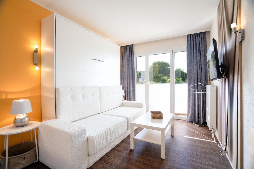 Postel nebo postele na pokoji v ubytování Das Solaris 18 Beach Apartment mit Gemeinschaftssauna und Grillplatz