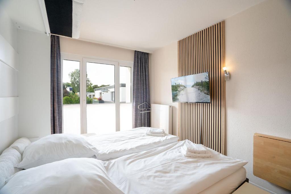 Postel nebo postele na pokoji v ubytování Das Solaris 18 Beach Apartment mit Gemeinschaftssauna und Grillplatz