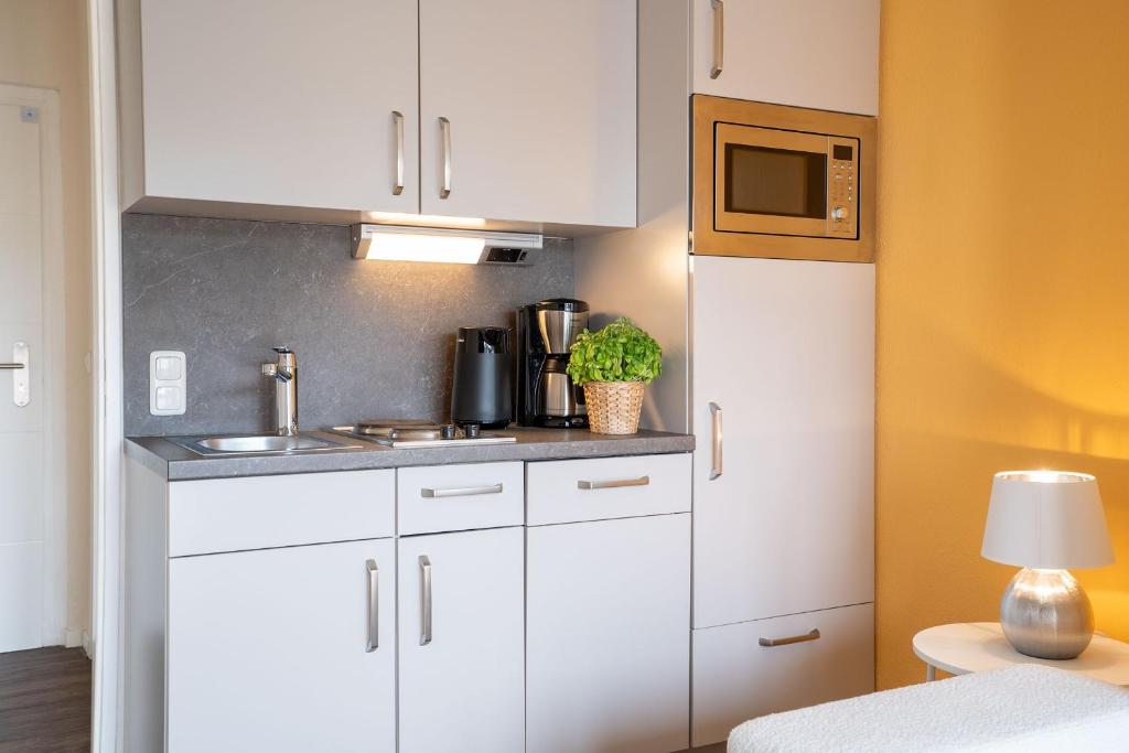 Kuchyň nebo kuchyňský kout v ubytování Das Solaris 18 Beach Apartment mit Gemeinschaftssauna und Grillplatz