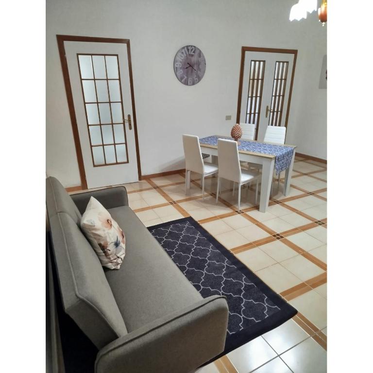 a living room with a couch and a table at Ocean's Holiday House in Terrasini