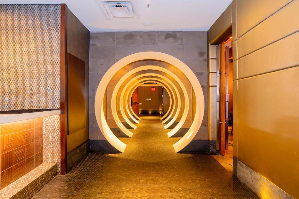 a long hallway with a row of lights on the wall at Sandman Signature Vancouver Airport Hotel & Resort in Richmond