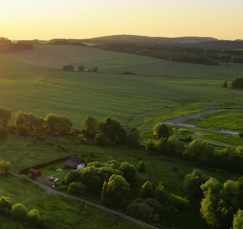 an aerial view of a field with a barn and a road at Sielanka Chwaliszów dom całoroczny in Chwaliszow