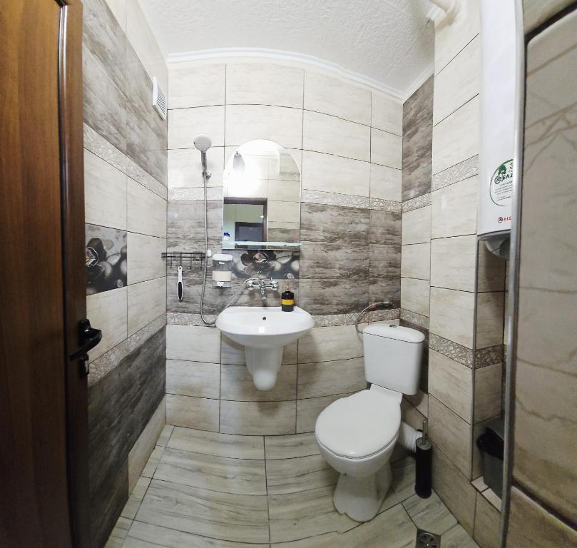 a bathroom with a toilet and a sink at Зара Апартамент in Stara Zagora
