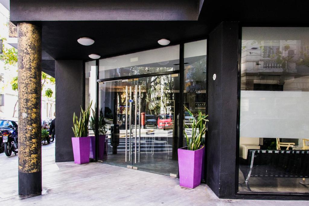 a store front with pink pots with plants in it at Épico Recoleta Hotel in Buenos Aires