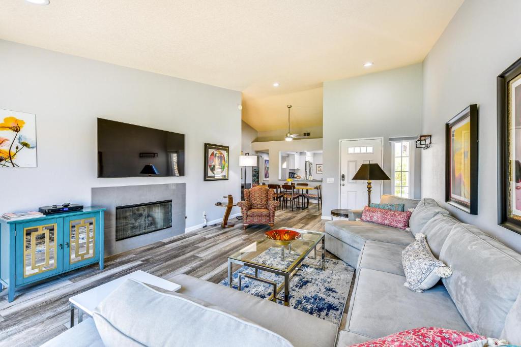 a living room with a couch and a fireplace at Pool Access Newly Renovated Palm Desert Condo in Palm Desert