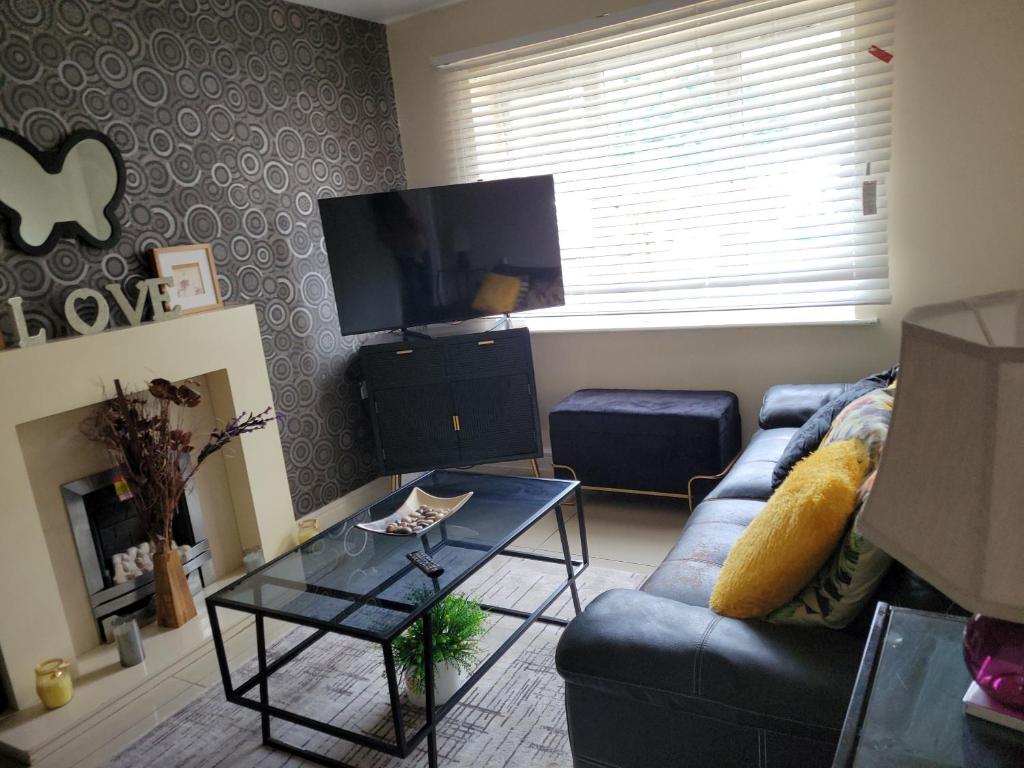 a living room with a couch and a tv at Bed 4 night in Manchester