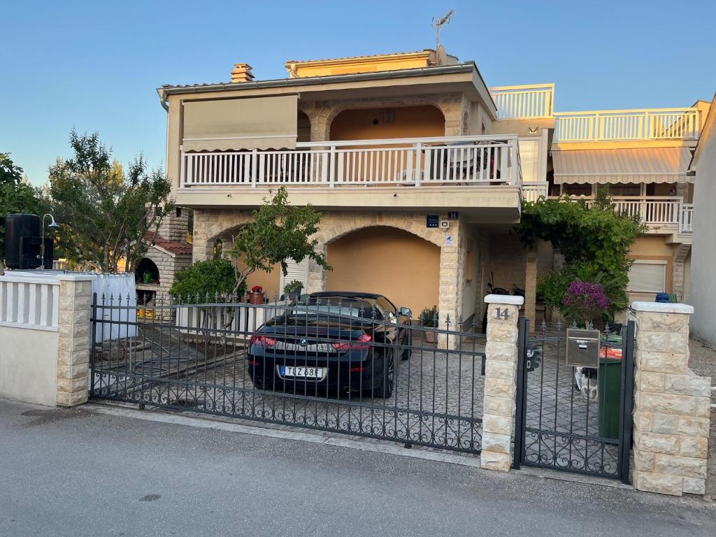 a black car parked in front of a house at Villa Ella in Pirovac