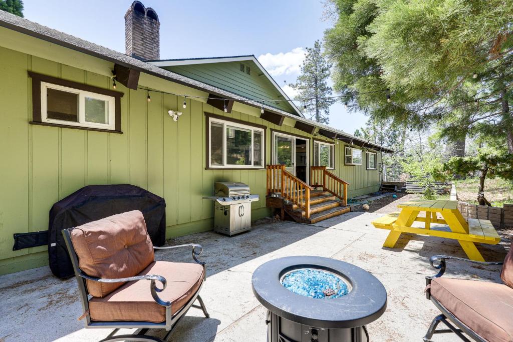 a patio of a green house with a table and chairs at Private Hot Tub at Dog-Friendly Lake Arrowhead Gem in Lake Arrowhead