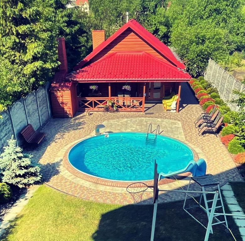 an overhead view of a swimming pool in front of a house at НО home in Kholodnovidka