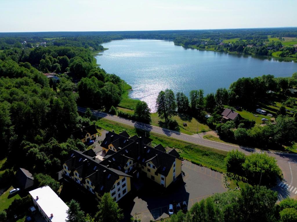 Aerial view of a lakeside property surrounded by lush greenery.