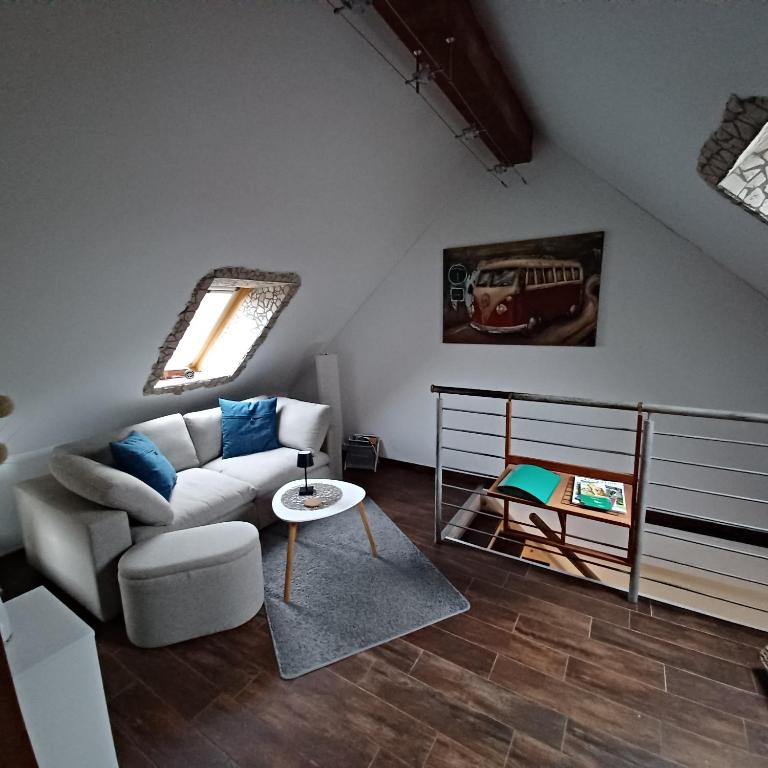 a living room with a couch and a table at Schulzis Ferienwohnung in Windeck